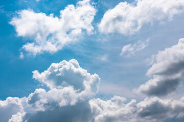 Fluffy clouds in the bright  blue sky