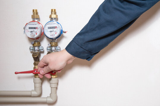 A Man Turns Off A Hot Water Faucet. Planned Shutdown Of Hot Water And Repair Of The Heating Main. Copy Space For Text