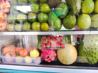 Several variants of fruit displays at a fruit juice seller
