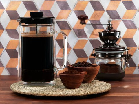 Making cold brew coffee with milk in a french press, also known as a cafetière, coffee press, or coffee plunger