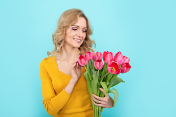 happy young woman with spring tulip on blue background