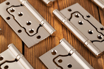 door metal hinges on a wooden background, macro. Door furniture