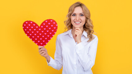 happy woman with red love heart on yellow background. sweetheart