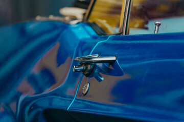 Side view of a shiny American muscle car Ford Mustang blue with a chrome door handle. Ford Mustang...