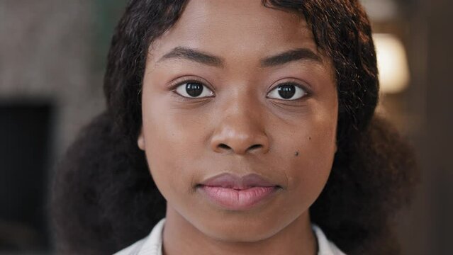 Female portrait indoors alone serious calm confident African American businesswoman intern student girl with perfect skin woman looking at camera in office workspace at home bullying racism feminism
