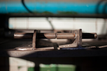 Steel part. Thick metal. Drilled holes in workpiece. Details of metal workshop. Background of part of structure.