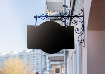 Mockup, big black sign against the background of the sky and the old house