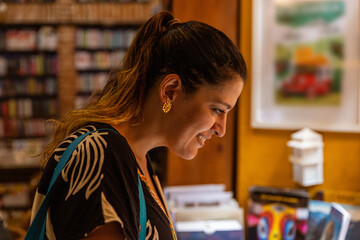 latina woman smiling in a library