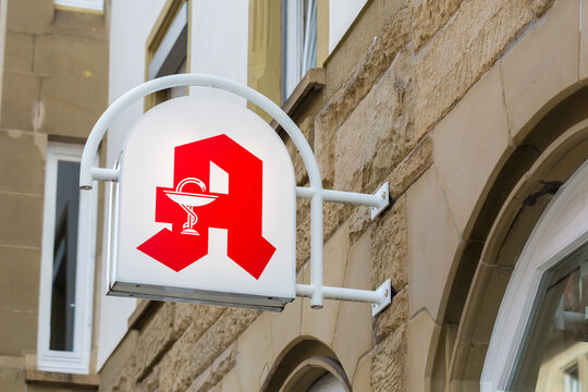 Stuttgart, Germany - Jul 29, 2021: Close up of an Apotheke (pharmacy) sign. Symbol for health, medicine and medical supplies.