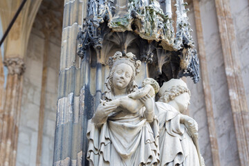 Close-up of a Mary statue with newborn Jesus at the main portal Ulm Cathedral.