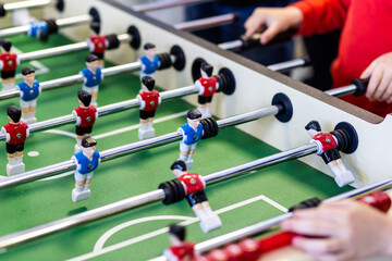 Blurred table football with shiny chrome figures close up