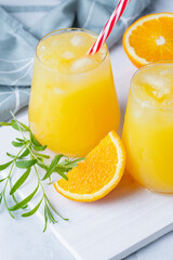 Obraz na płótnie Canvas Glass of orange juice with ice. Cold orange fresh. Glass of orange juice for hot summer day