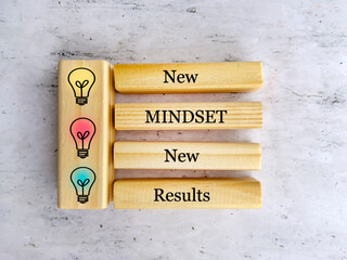 New mindset new results quote on wooden cubes with colorful light bulbs  - obrazy, fototapety, plakaty