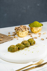 Pistachio baklava on white marble. Traditional middle eastern dessert. Turkish Antep baklava.