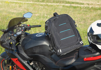 Backpack with a motorcycle at outdoors. Ready for adventure and travel