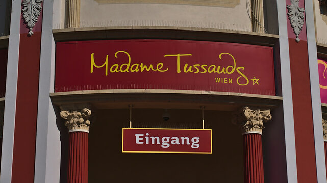 Vienna, Austria - 03-21-2022: Close-up view of red colored sign above the entrance of wax musem Madame Tussauds in amusement park Wurstelprater in Vienna, Austria with logo.