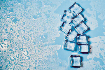 Ice cubes on studio blue background. The concept of freshness with coolness from ice cubes.