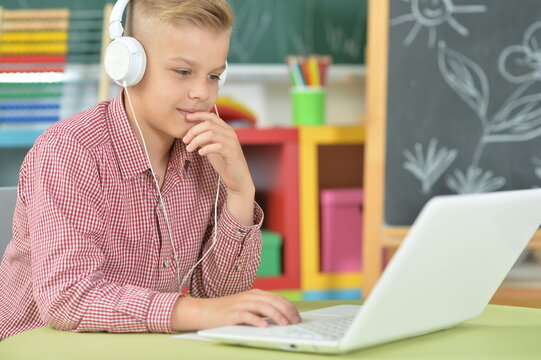 boy with headphones using laptop