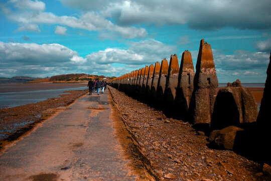 View of a group of tourists walking in Cramond Island, Scotland