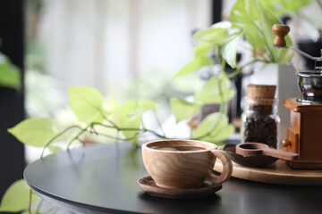 Wooden coffee cup utensil and plant pot on black table indoor drinking