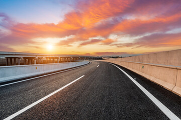 Empty asphalt road and sky clouds at sunrise. Road and sky background.