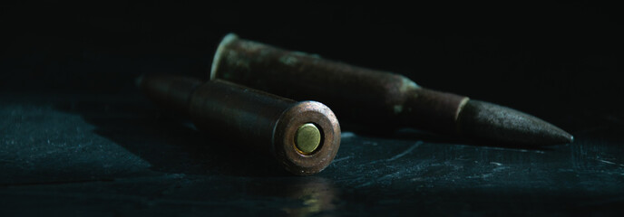 Old bullets with ammunition on a dark background close-up. The concept of modern armaments and wars