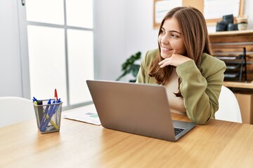 Young hispanic woman smiling confident working at office