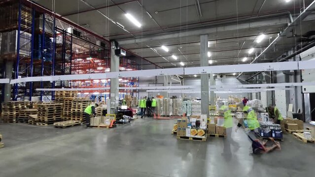 People work in a warehouse timelapse. People work in a large warehouse. Timelapse in a modern warehouse. Work with a modern warehouse