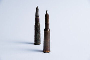 Cartridges with shell casings close up on a white background with space for text