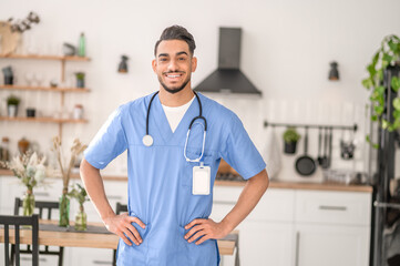 Merry healthcare worker in uniform looking before him