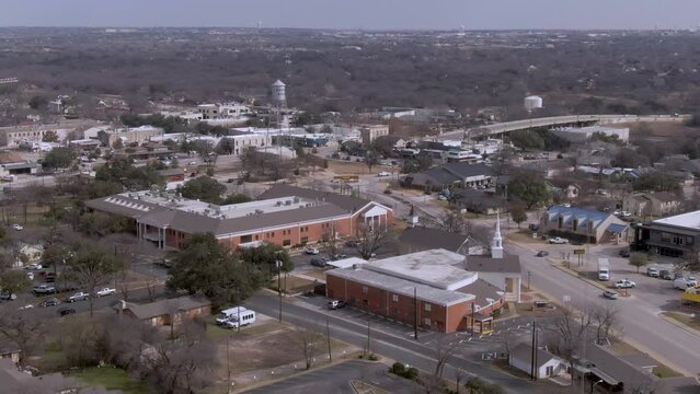 Aerial pan up of downtown Round Rock, Texas on a sunny day.