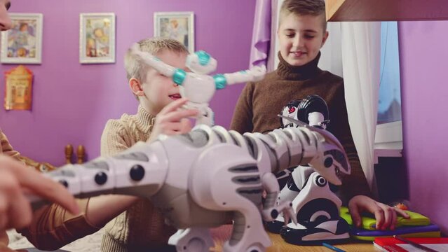 Happy kids playing with toy robots at home