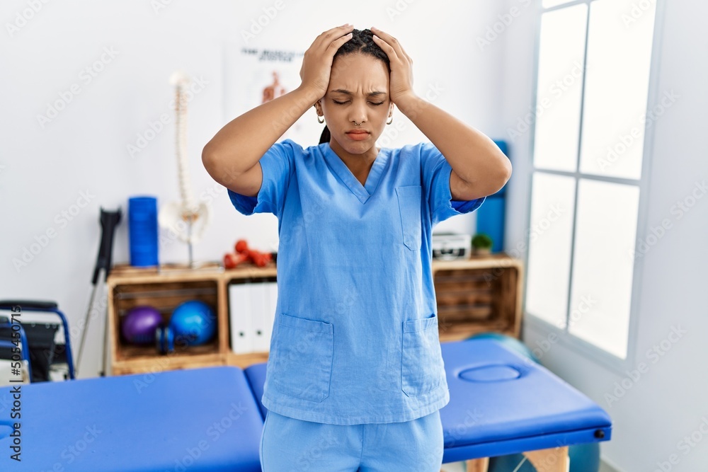 Sticker young african american woman working at pain recovery clinic suffering from headache desperate and s