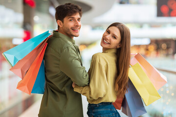 Married Couple Enjoying Shopping Walking In Hypermarket Indoors