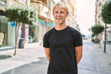 Young caucasian man smiling confident at street