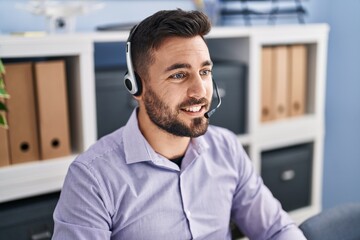 Young hispanic man call center agent working at office - obrazy, fototapety, plakaty