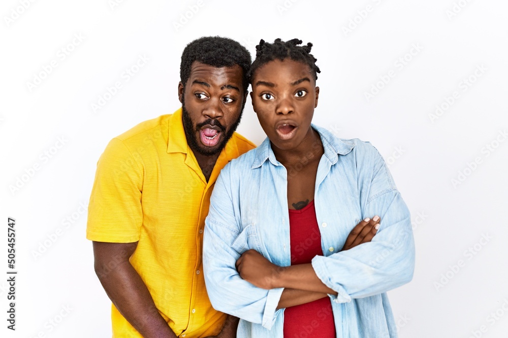 Sticker young african american couple wearing casual clothes afraid and shocked with surprise expression, fe