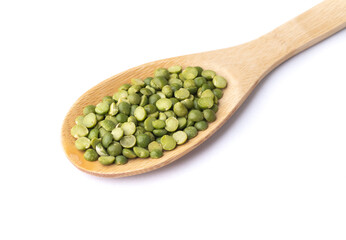 Raw dried green peas in a spoon isolated over white background