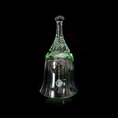 antique green crystal bell. vintage green glass festive bell on black isolated background