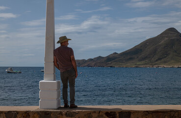 Rear view of adult man looking at view of sea