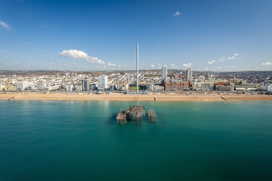 Panoramic view of the remains of Brighton West Pier on the background of British Airways i360