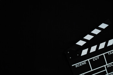 Fototapeta na wymiar Clapperboard, Film production and movie making concept, on black brick background