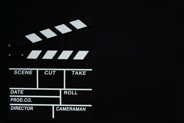 Fototapeta na wymiar Movie clapperboard on black background