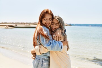 Young lesbian couple of two women in love at the beach. Beautiful women together at the beach in a romantic relationship