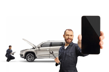 Man in a uniform showing a smartphone and mechanic checking a suv