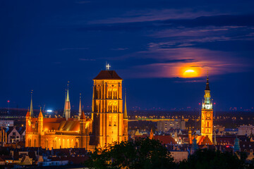 Fototapeta premium A full moon rising over the city of Gdansk at dusk, Poland