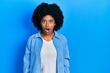 Fototapeta na wymiar Young african american woman wearing casual clothes afraid and shocked with surprise and amazed expression, fear and excited face.