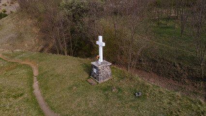 View of a memorial cross in a field on a sunny day