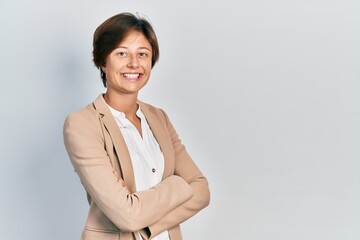 Young business woman smiling happy and confident with crossed arms standing over isolated background