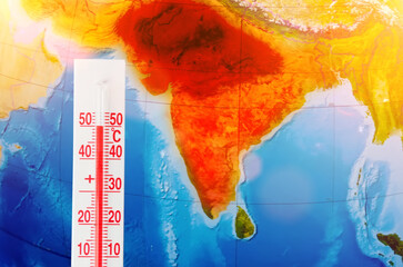 Thermometer with a record high temperature of fifty degrees Celsius, against the backdrop of the continent of the Indostan subcontinent. Hot weather concept. - obrazy, fototapety, plakaty